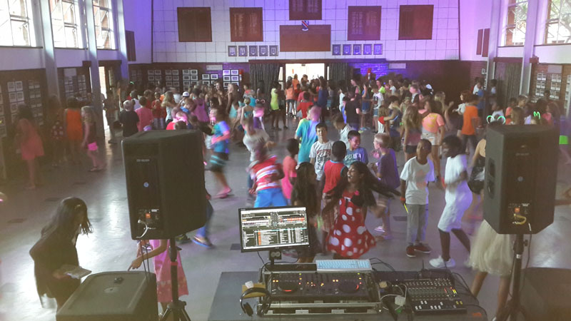 A lively school function viewed from the DJ booth